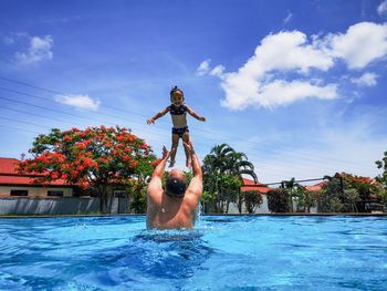 Father and daughter have fun in the pool