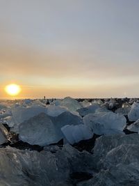 Scenic view of frozen sea against sky during sunset