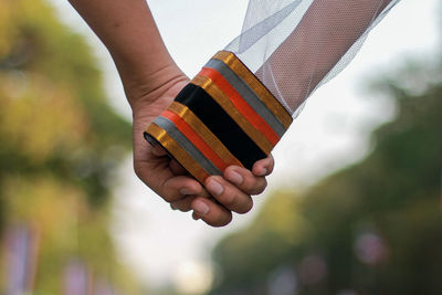 Cropped image of couple holding hands outdoors