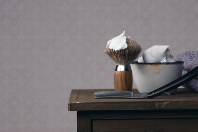 Close-up of shaving equipment on table