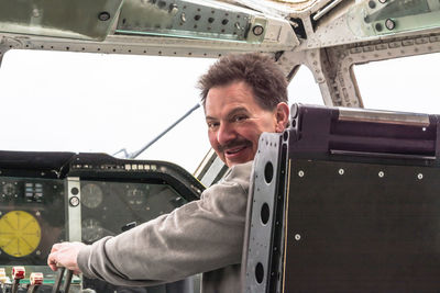 Portrait of man sitting in air vehicle cockpit