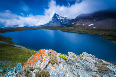 Scenic view of lake and mountains against sky