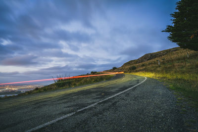 Empty road along countryside landscape