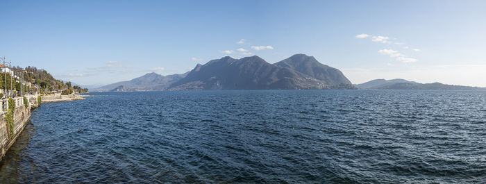 Scenic view of sea and mountains against sky