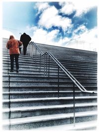 Low angle view of people walking on stairs