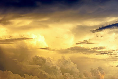 Low angle view of strong rain clouds in sky during sunset