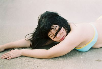 Portrait of young woman sitting on floor at home