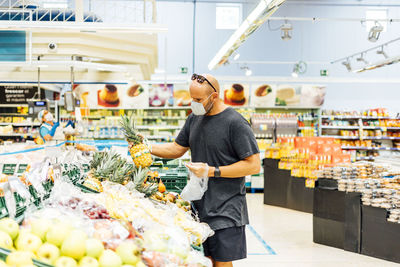 Man buying fresh fruit in supermarket