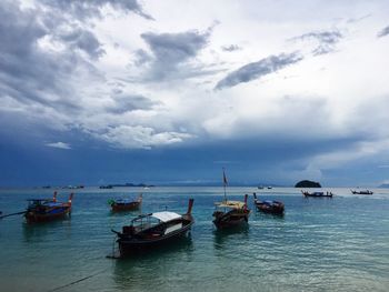 Boats moored in sea against sky