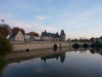 Bridge over river with buildings in background