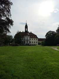 Lawn by building against sky