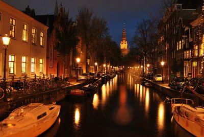 View of boats moored at night