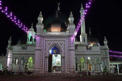 Low angle view of illuminated building at night