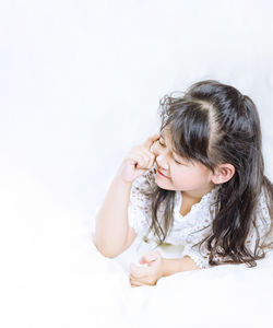 Close-up of a young woman over white background