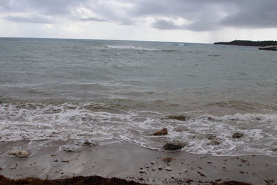 Scenic view of sea against cloudy sky