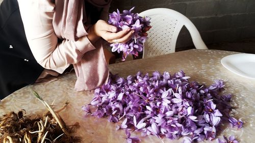 Midsection of woman holding bouquet