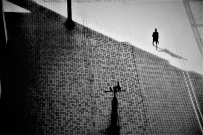 Silhouette man and woman walking on floor