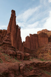 Hiker heads down path under the fisher towers near moab utah