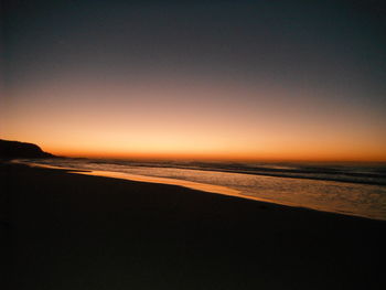 Scenic view of beach against sky during sunset
