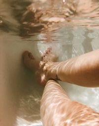 Low section of woman in bathtub