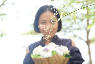 Close-up of young woman with flowers