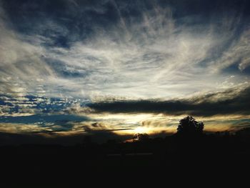 Scenic view of silhouette landscape against dramatic sky