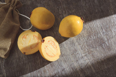 Yellow guava on wooden background. vitamin c, healthy fruit diet.