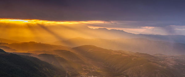 Scenic view of mountains against sky during sunset