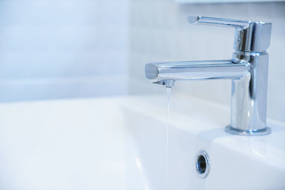 Close-up of faucet in bathroom