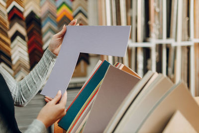 Midsection of woman reading book