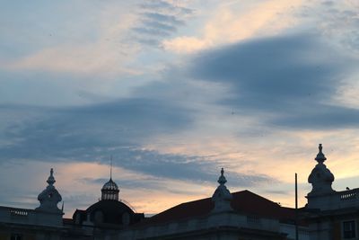 Low angle view of building against cloudy sky