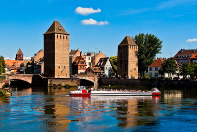 River amidst buildings against sky