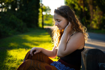 Young woman sitting on field