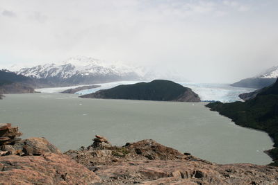 Scenic view of lake and mountains against sky