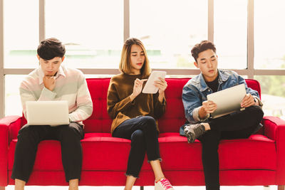 Young couple sitting on laptop