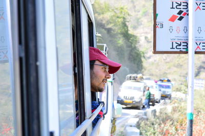 Portrait of man looking through car window