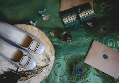 Directly above shot of peacock feathers and shoes on table