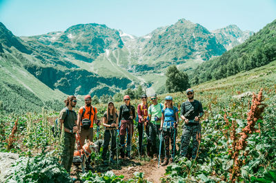 Panoramic shot of people on mountain range against sky