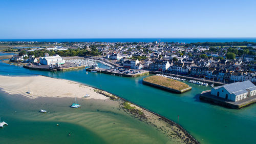 High angle view of residential district by sea against sky