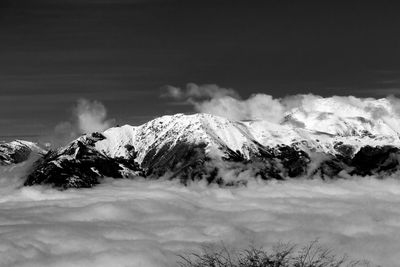 Scenic view of snow covered mountains against sky