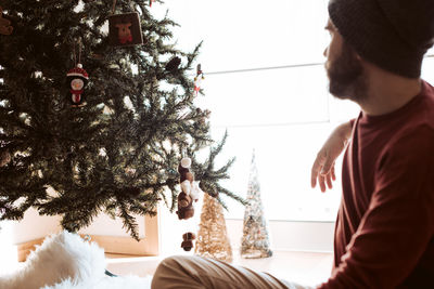 Midsection of man with christmas tree