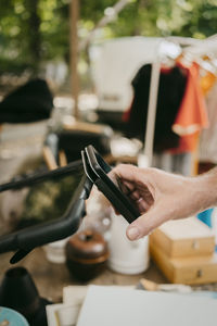 Man paying through digital wallet while shopping at flea market