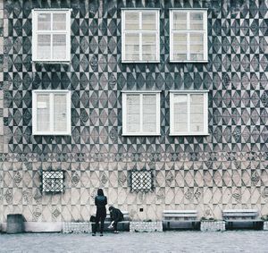People walking on brick wall