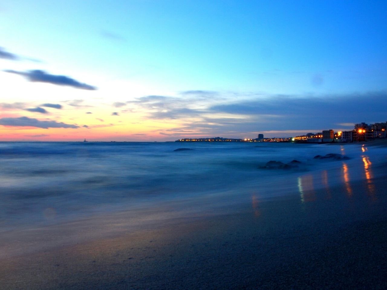 sea, water, horizon over water, beach, sunset, scenics, sky, beauty in nature, tranquil scene, shore, tranquility, nature, idyllic, wave, blue, cloud - sky, dusk, sand, coastline, orange color