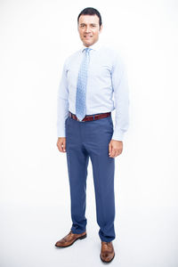 Portrait of smiling man standing against white background