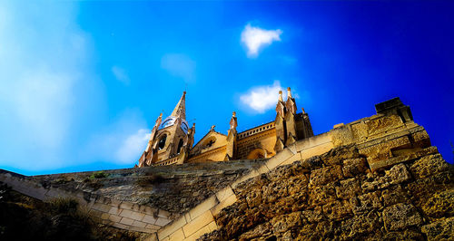 Low angle view of traditional building against blue sky