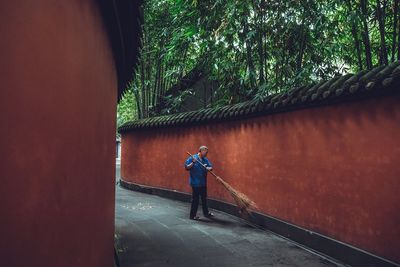 Rear view of man standing by tree