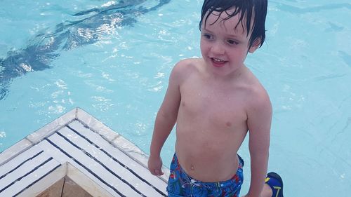 Portrait of happy boy in swimming pool