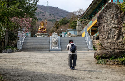 Full length of man standing in temple outside building