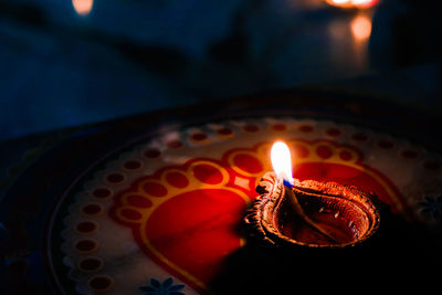 Close-up of lit candle in the dark